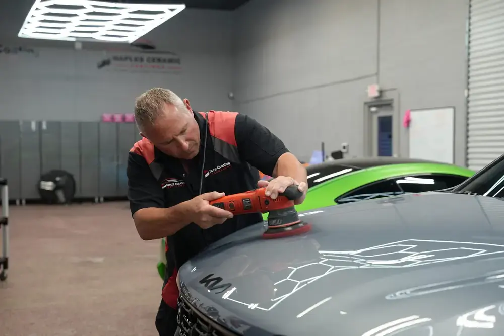 A Naples Ceramic Coatings technician polishing a hood before coating