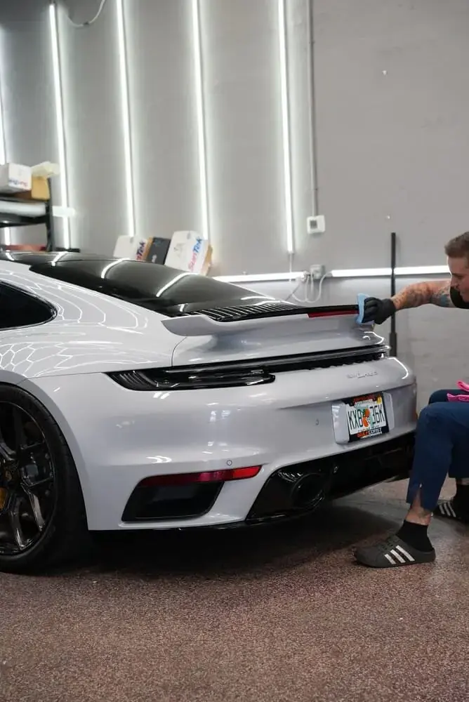 A Porsche 911 being worked on inside the Naples Ceramic Coatings shop